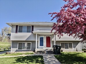 Stunning two-story home with a central entrance, flanked by windows and a satellite dish.