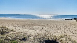 A beach with a clear sky and calm sea. - Beautiful, Spacious, Beachfront Home - Perfect for Entertaining Family & Friends (West Haven)