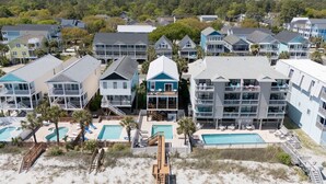 A coastal hotel with multiple buildings, a beach area with a wooden walkway, and several swimming pools. - Oceanfront 5 BR Beach House in Surfside Beach with Private Pool! LA ESMERALDA II (Surfside Beach)