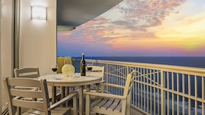 A balcony with a table set for two, featuring a bottle of wine and glasses. - 2507 Margate - 4 bedroom ocean front condo - (Myrtle Beach)