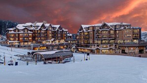 A large lodge with multiple floors and a ski lift in the foreground.