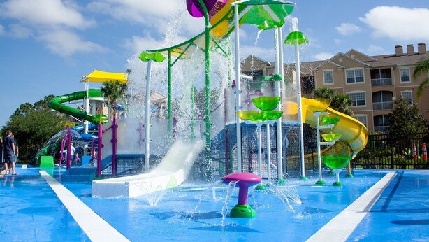 A water park with multiple slides and water features. - Windsor Hills Resort Condo-Disney, Golf, and Fun! (Kissimmee)