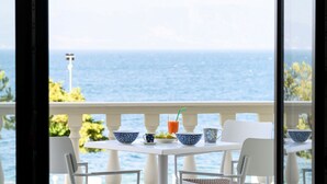 A table set with bowls, a cup, and a glass of juice on a balcony with a view of the sea. - Villa Filoxenia - by the sea - up to 12 guests (Aigialeia)
