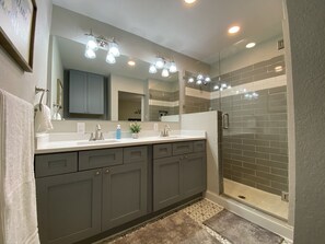 Combined shower/bathtub, towels, soap, toilet paper