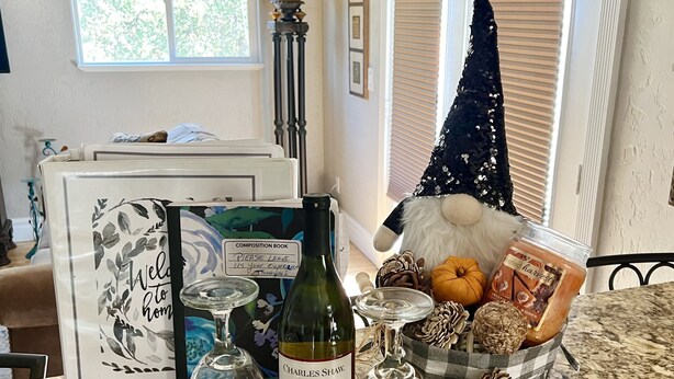 A kitchen counter with a wine bottle, glasses, a composition book, and a decorative tree. - Beautiful and Relaxing Guest House!! (Redding)