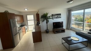 A modern apartment with a kitchen, living area, and balcony. - Villa Aqua Sunrise 1km From Beach With Sea Views (Coral Bay Peyia Paphos)