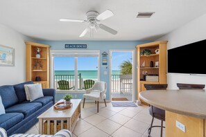 Relax in this open-plan living area with ocean views, a ceiling fan, and a flat-screen TV.
