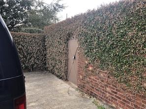 entrance with secure fencing and a designated parking area.
