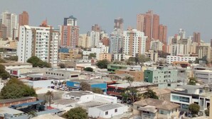 A cityscape with numerous high-rise buildings and a mix of residential and commercial structures.