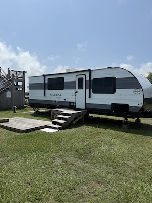 Park your RV on this grassy site, featuring a ramp for easy access and an outdoor shower.