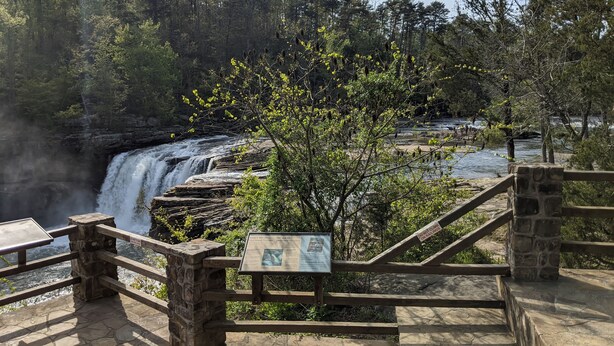 A stone staircase leading to a viewing platform overlooking a waterfall. - Faye's Retreat (Fort Payne)