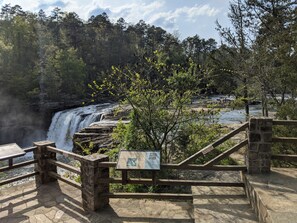 A stone staircase leading to a viewing platform overlooking a waterfall. - Faye's Retreat (Fort Payne)