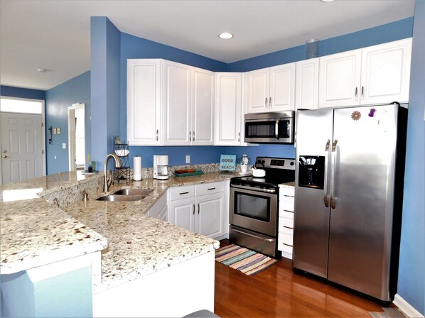 Enjoy cooking in this kitchen with a sink, microwave, oven, and refrigerator.
