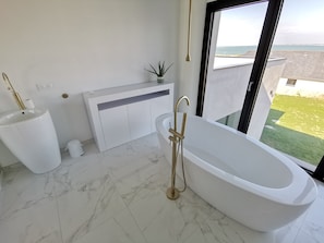Combined shower/tub, hair dryer, towels, soap
