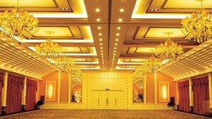 A grand hall with chandeliers, a patterned carpet, and a large door. - Beijing Chunhuiyuan Hot Spring Resort Hotel (Beijing)