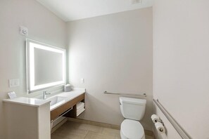 A bathroom with a white sink, mirror, and toilet. - Holiday INN Express Suites Lindale (Lindale)