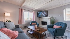 A living room with a fireplace, two armchairs, a sofa, and a coffee table. - The Pineapple Suite, Whitewater Views steps to Sand  (San Clemente)