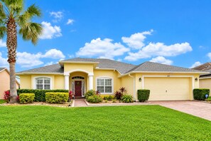A single-story house with a front entrance, a garage, and a well-maintained lawn.