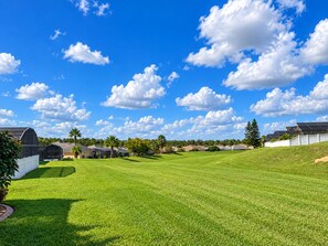 Un campo de golf con cielo despejado y nubes dispersas.