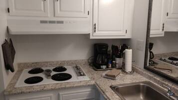 Fridge, microwave, coffee/tea maker, cookware/dishes/utensils