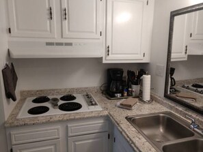 Fridge, microwave, coffee/tea maker, cookware/dishes/utensils