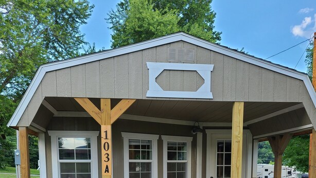 A small, single-story building with a porch, two windows, and a door. - The Corner Shed- Norris Lake or the Mountains (Jacksboro)