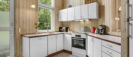 Fridge, stovetop, dishwasher, coffee/tea maker