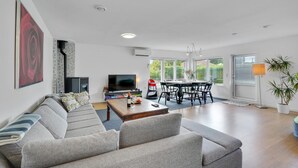 A modern living room with a sofa, TV, dining table, and chairs. - Amazing home in Frederiksværk with WiFi (Frederiksværk)