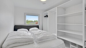 A bedroom with a bed, a window, and a white wardrobe. - Amazing home in Frederiksværk with WiFi (Frederiksværk)