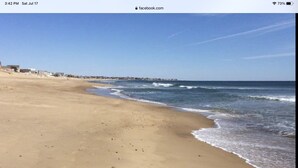 A beach with a clear sky and calm sea.
