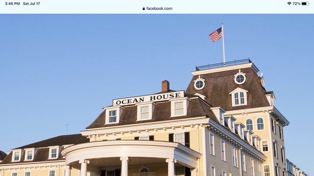 A large, historic building with a sign reading "OCEAN HOUSE."