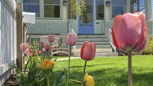 A house with a front porch, a mailbox, and a number '12' on the steps.