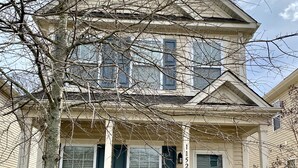 A two-story house with a front porch, a mailbox, and a brick pathway leading to the entrance. - Quiet and Beautiful House in a WONDERFUL location near 2 Lakes and Charlotte! (Huntersville)