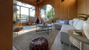 Un intérieur chaleureux en bois, avec une cheminée, un canapé et une table à manger.