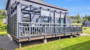 A modern building with large windows, a balcony, and a wooden deck. - Willa anna b by Interhome (Kemiönsaari)