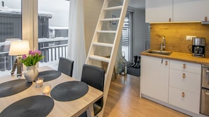 A modern kitchen with a wooden countertop, white cabinets, and a stainless steel sink. - Willa anna b by Interhome (Kemiönsaari)