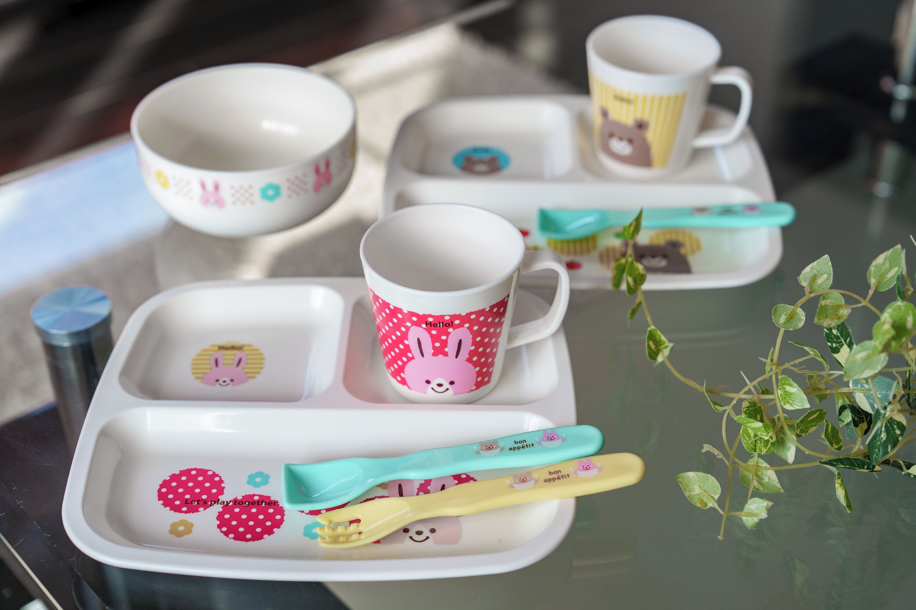A tray with cups, a toothbrush, and a plant.