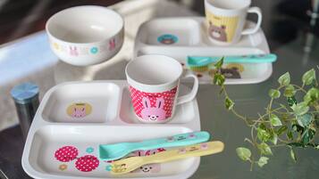 A tray with cups, a toothbrush, and a plant.