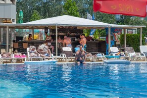 A pool area with lounge chairs and a bar under a canopy. - Aparthotel Poseidon - All inclusive (Sunny Beach)