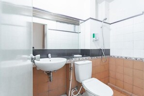 A small bathroom with a white sink, toilet, and shower. - Capital O 3932 Hotel Setrasari (Bandung)