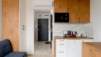 Design Apartment | Private kitchen | Fridge, microwave, stovetop, high chair