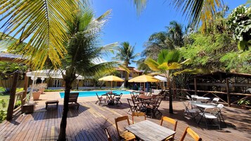 Una piscina al aire libre, camas de piscina gratis, sombrillas
