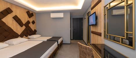 Une chambre d’hôtel avec deux lits, un bureau, une chaise, une télévision et un miroir.