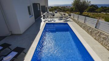 Seasonal outdoor pool, open 9:00 AM to 9:00 PM, pool umbrellas