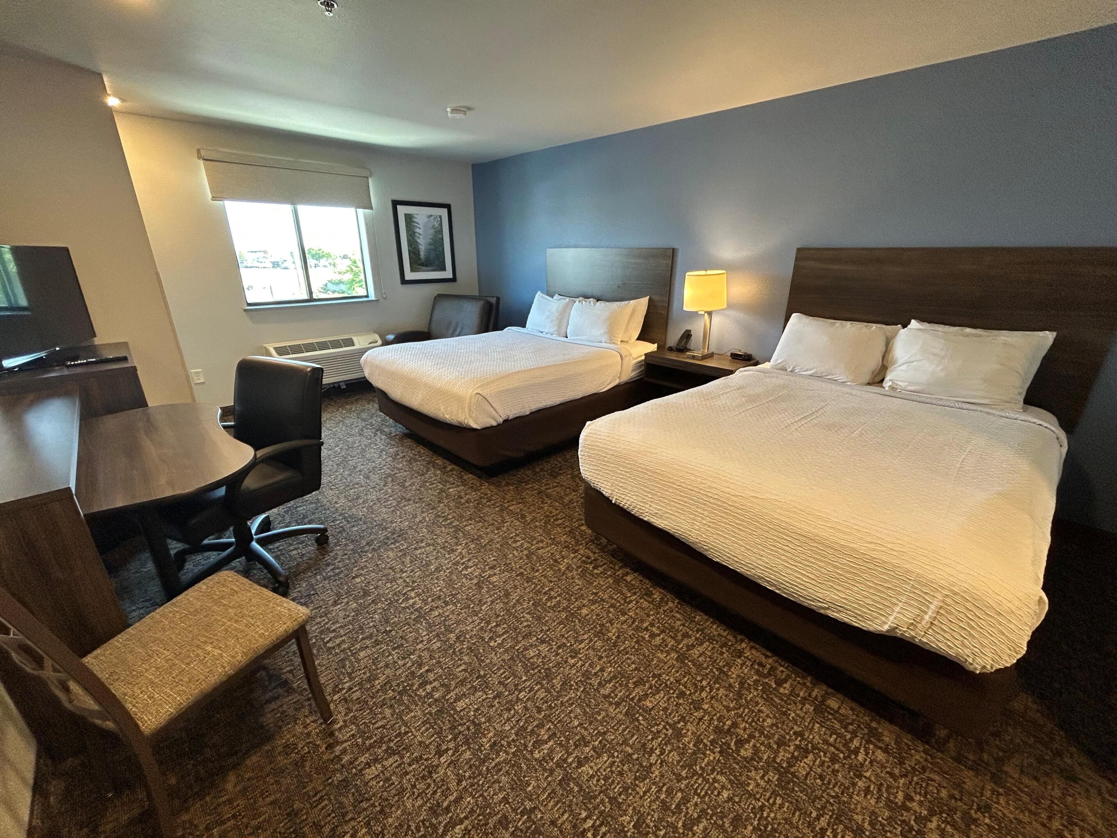 Premium bedding, pillow-top beds, desk, laptop workspace