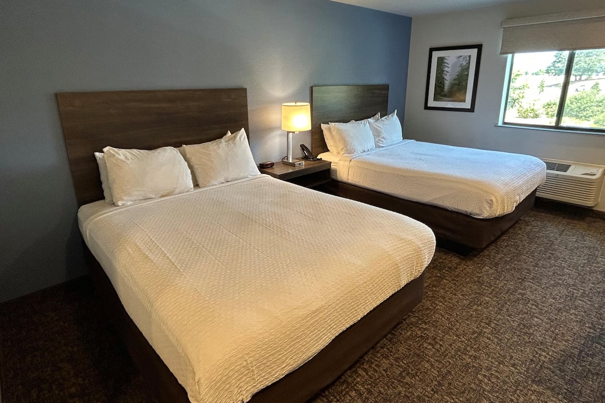 Premium bedding, pillow-top beds, desk, laptop workspace