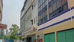A multi-story building with large windows and a tiled facade. - OYO 4001 Kalideres Residence Syariah (Jakarta)