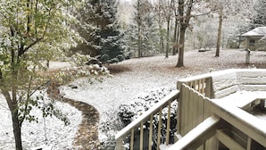 A snow-covered deck with a view of a leafless tree and a wooden pathway. - 30 min from Notre Dame + Hottub, 10 acre estate and game room (Edwardsburg)