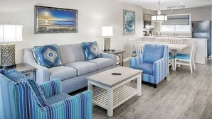 A living room with a sofa, armchairs, a coffee table, and a dining area with a table and chairs. - Edisto 2BR W/Resort Amenities and beach access (Edisto Island)
