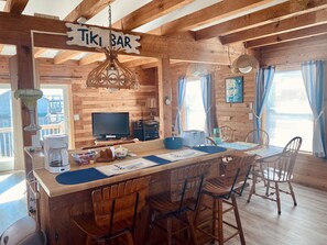 Relax in this cabin with a spacious island bar area, perfect for socializing, and enjoy amenities like a TV, coffee maker, and toaster.